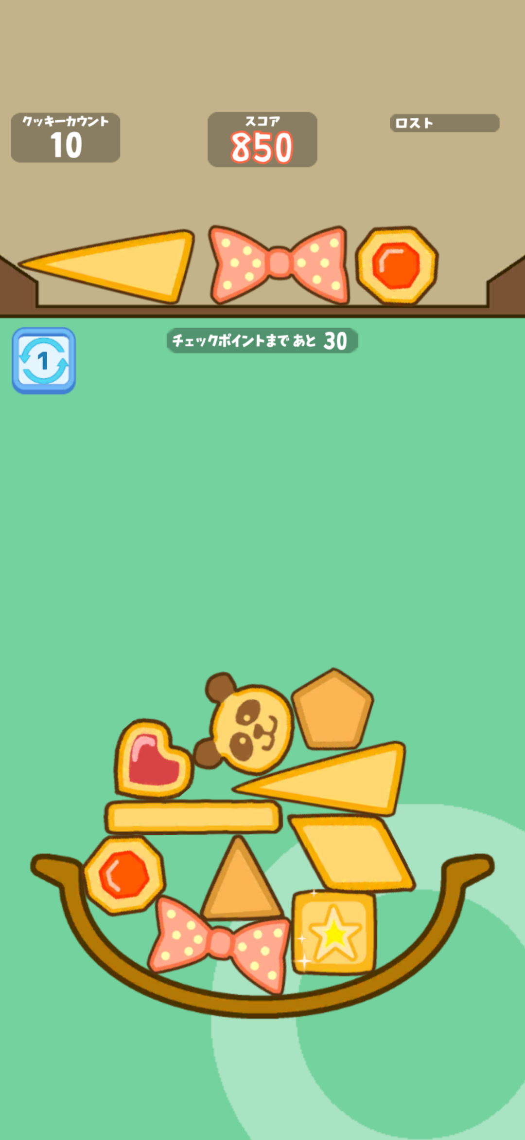 クッキータワーチャレンジのプレイ画面|お菓子を受け皿に積んでバランスを取る場面