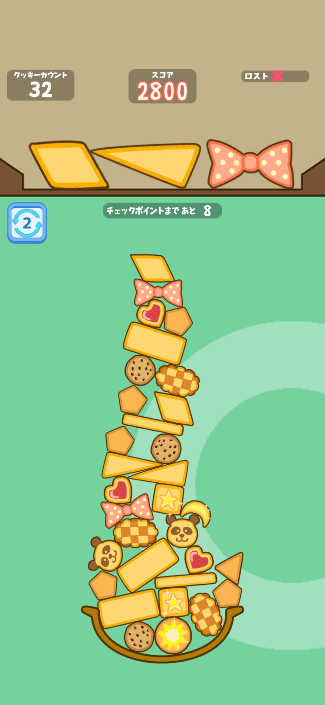 クッキータワーチャレンジのタワー|お菓子を高く積み上げていく場面